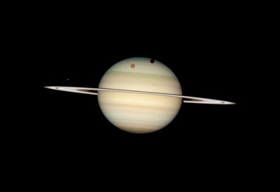 Four of Saturns moons transiting the planet as seen by HST. (Click to embiggen -- caution-huge image!)